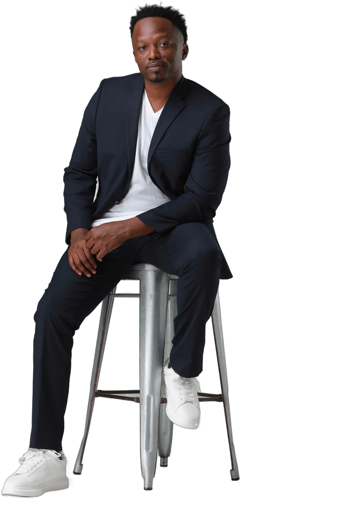 Brian D. Washington, Creative Director, seated in a dark suit